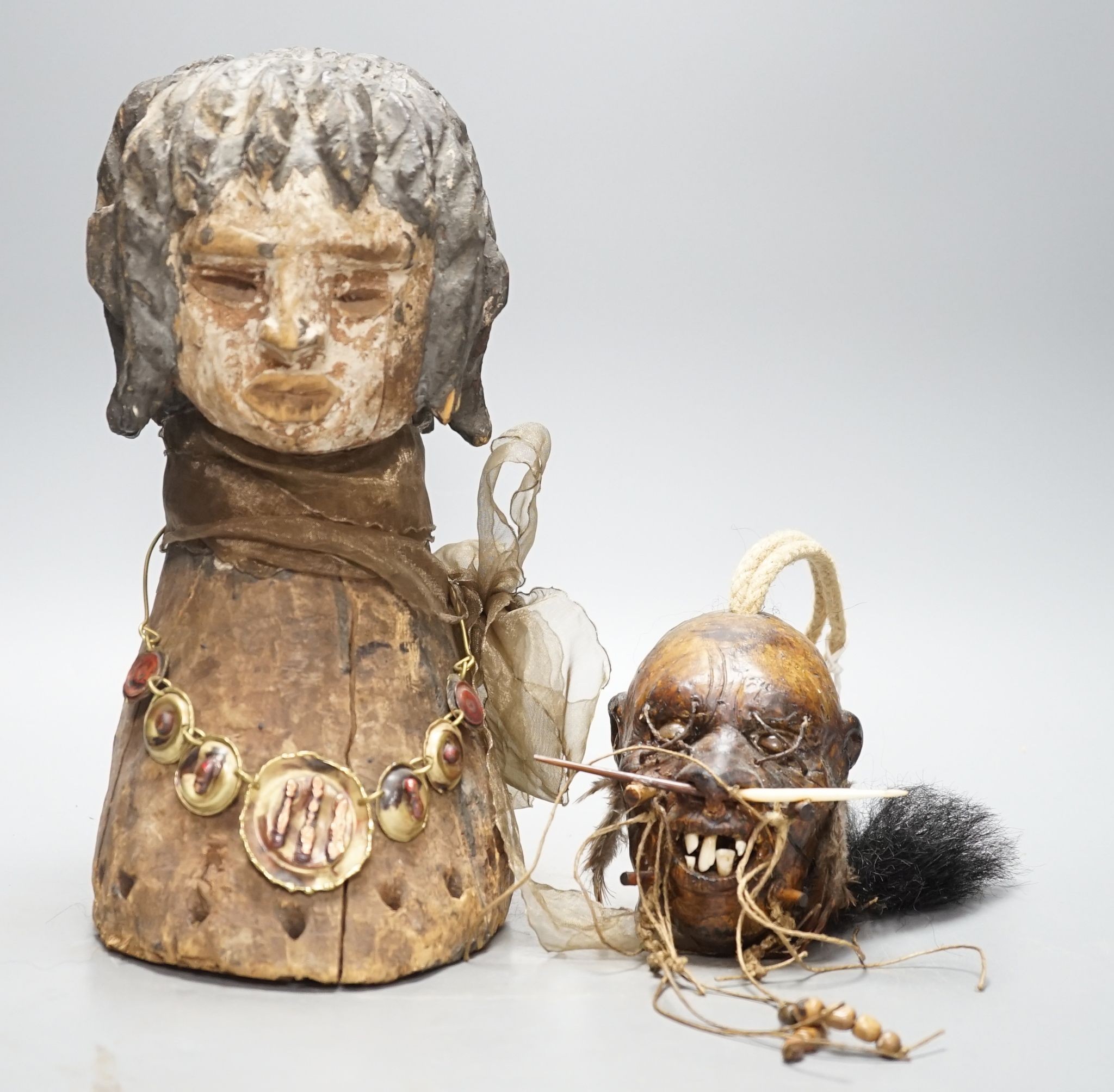 An African tribal carving, 31cm and a pottery model of a shrunken head
